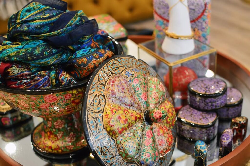 A variety of handcrafted ceramics in different shapes, colors, and patterns, showcasing the artistry and detail of traditional Kashmiri techniques.